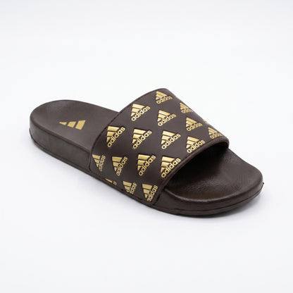 Angled view of men brown slide slipper with printed gold strap